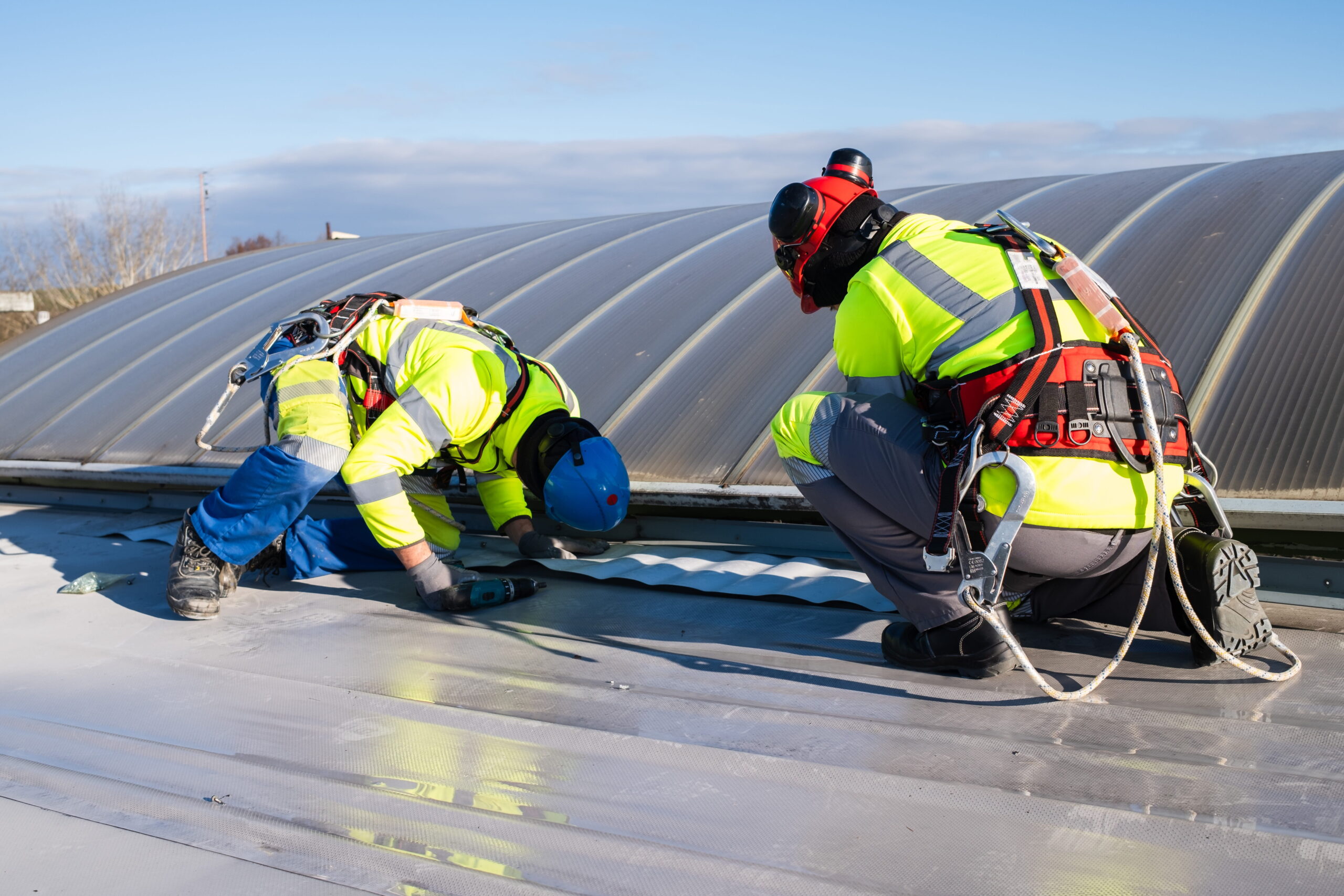 SBOIQ Two Roofers Sealing A Flat Roof sboiq-two-roofers-wearing-helmets-and-harness-sealing-a-flat-roof